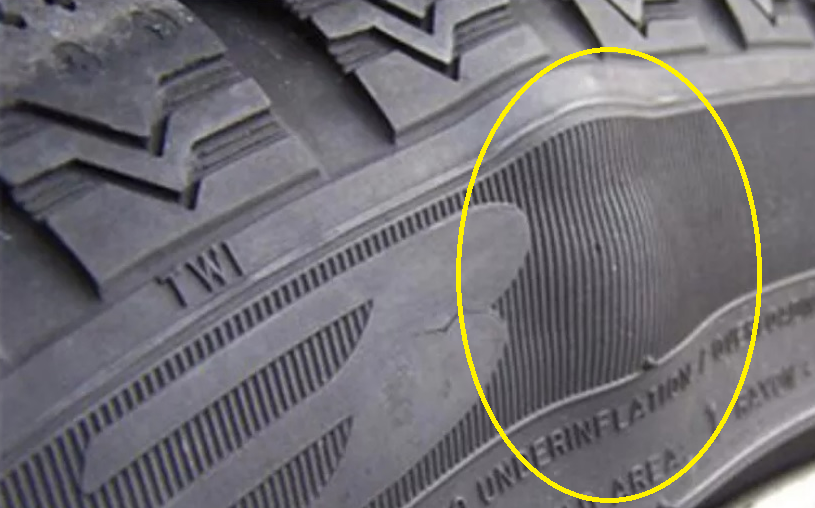Tire Bulging shown in car tire with yellow marked area