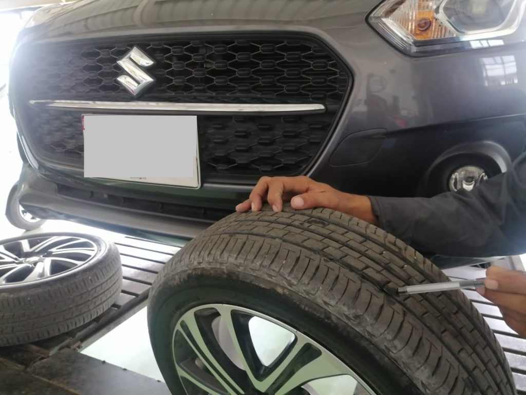 Inspecting Suzuki swift tires for tires cracking